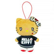 An officially licensed Sanrio Hello Kitty plush keychain with a tan "tanned" complexion, wearing a black logo jersey and a leopard print bow. The plush features heart-shaped eyes, a rhinestone cheek accent, and a red elastic loop for hanging.