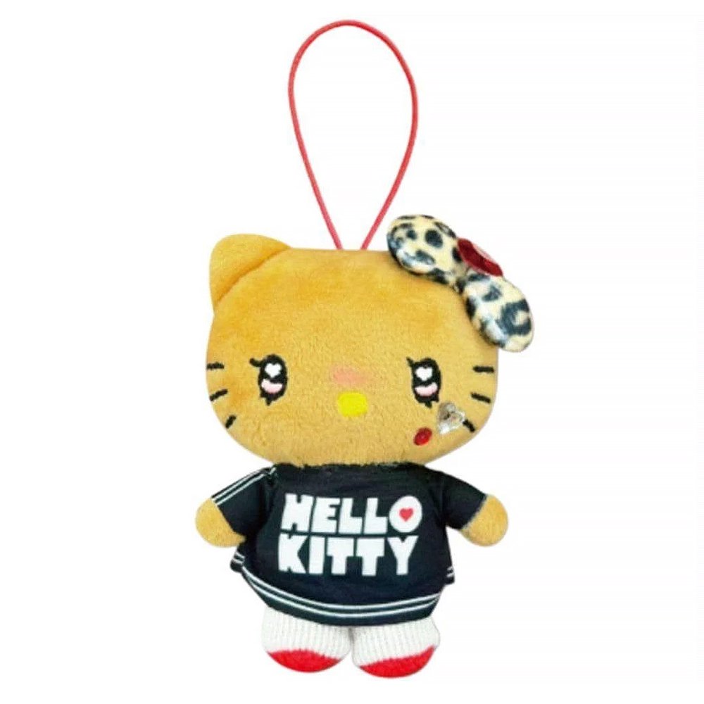 An officially licensed Sanrio Hello Kitty plush keychain with a tan "tanned" complexion, wearing a black logo jersey and a leopard print bow. The plush features heart-shaped eyes, a rhinestone cheek accent, and a red elastic loop for hanging.