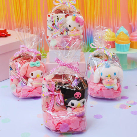 A collection of Sanrio Happy Birthday themed gift sets, each containing various colorful items such as plush keychains and socks, all packaged in clear gift bags with pink ribbons.