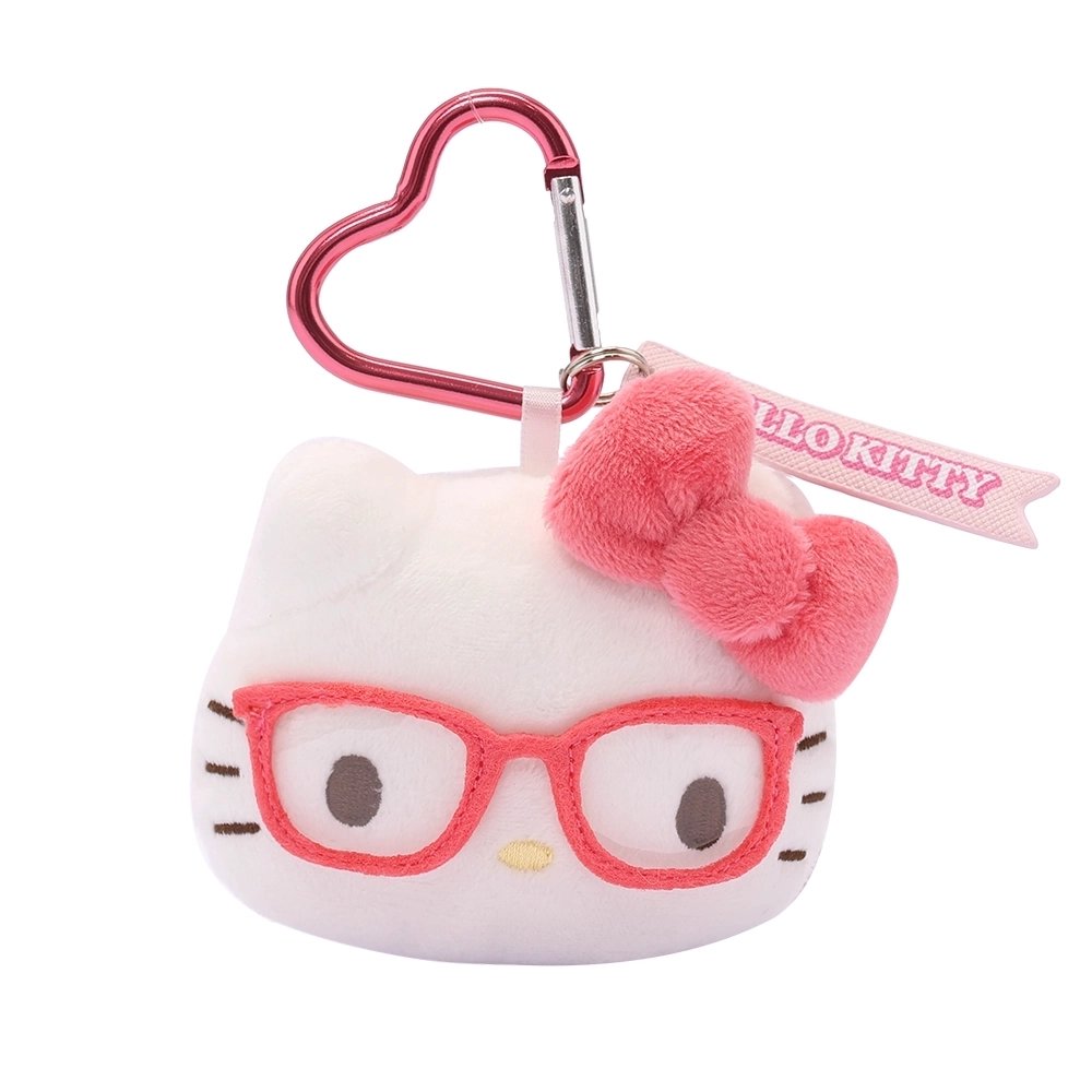 An officially licensed Sanrio Hello Kitty plush head keychain,  wearing embroidered pink glasses and a textured pink bow. The keychain features a pink, heart-shaped metal carabiner clip and a woven fabric tag that reads "HELLO KITTY." The sturdy, heart-shaped carabiner in a matching metallic pink finish, makes it easy to clip onto backpacks, purses, or belt loops.