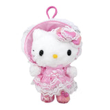 An officially licensed Sanrio Hello Kitty plush keychain wearing a pink Lolita-style dress and bonnet with white lace trim, featuring a pink heart bow and metallic pink shoes