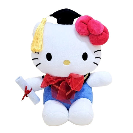 An officially licensed Sanrio 10-inch Hello Kitty graduation plush sitting upright, wearing a black graduation cap with a yellow tassel and a red bow around the neck while holding a white diploma
