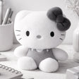 An officially licensed Sanrio Hello Kitty plush doll dressed in a grey outfit with a matching dark grey hair bow
