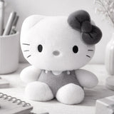 An officially licensed Sanrio Hello Kitty plush doll dressed in a grey outfit with a matching dark grey hair bow