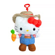 An officially licensed Hello Kitty plush clip-on wearing a straw hat and denim overalls, holding a plush carrot, with a red plastic clip.