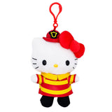 An officially licensed Hello Kitty plush keychain dressed as a firefighter, featuring a red and yellow striped uniform, a red fire helmet with a gold badge, her signature red bow, and a red plastic clip.