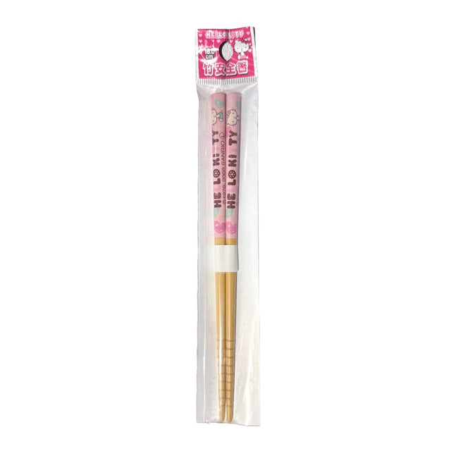 A pair of officially licensed Sanrio Hello Kitty bamboo chopsticks sealed in clear plastic packaging, featuring a pink upper handle decorated with Hello Kitty characters and text, and grooved tips at the bottom.