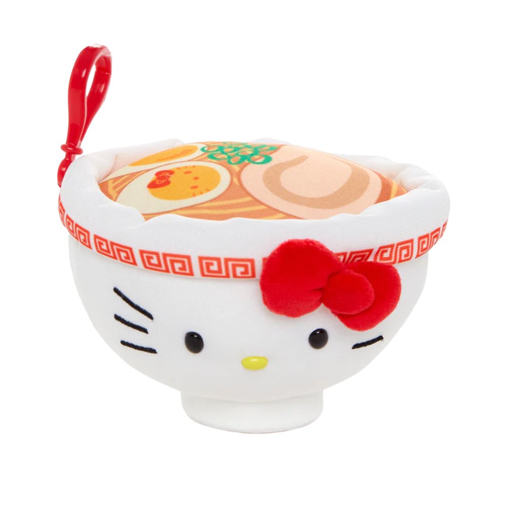 An officially licensed Sanrio plush keychain shaped like a white ramen bowl with Hello Kitty's face and a red bow. The top view shows a printed design of ramen noodles, green onions, and a Hello Kitty-themed egg.