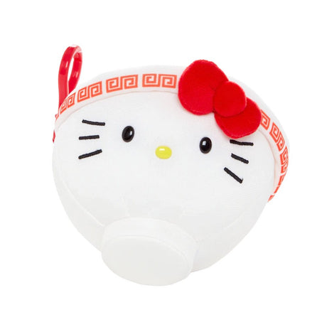 An officially licensed Sanrio plush keychain shaped like a white ramen bowl with Hello Kitty's face and a red bow. The top view shows a printed design of ramen noodles, green onions, and a Hello Kitty-themed egg.