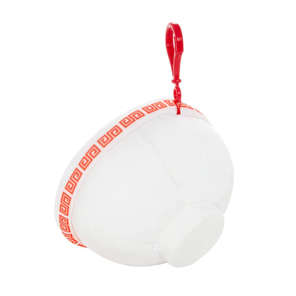 An officially licensed Sanrio plush keychain shaped like a white ramen bowl with Hello Kitty's face and a red bow. The top view shows a printed design of ramen noodles, green onions, and a Hello Kitty-themed egg.