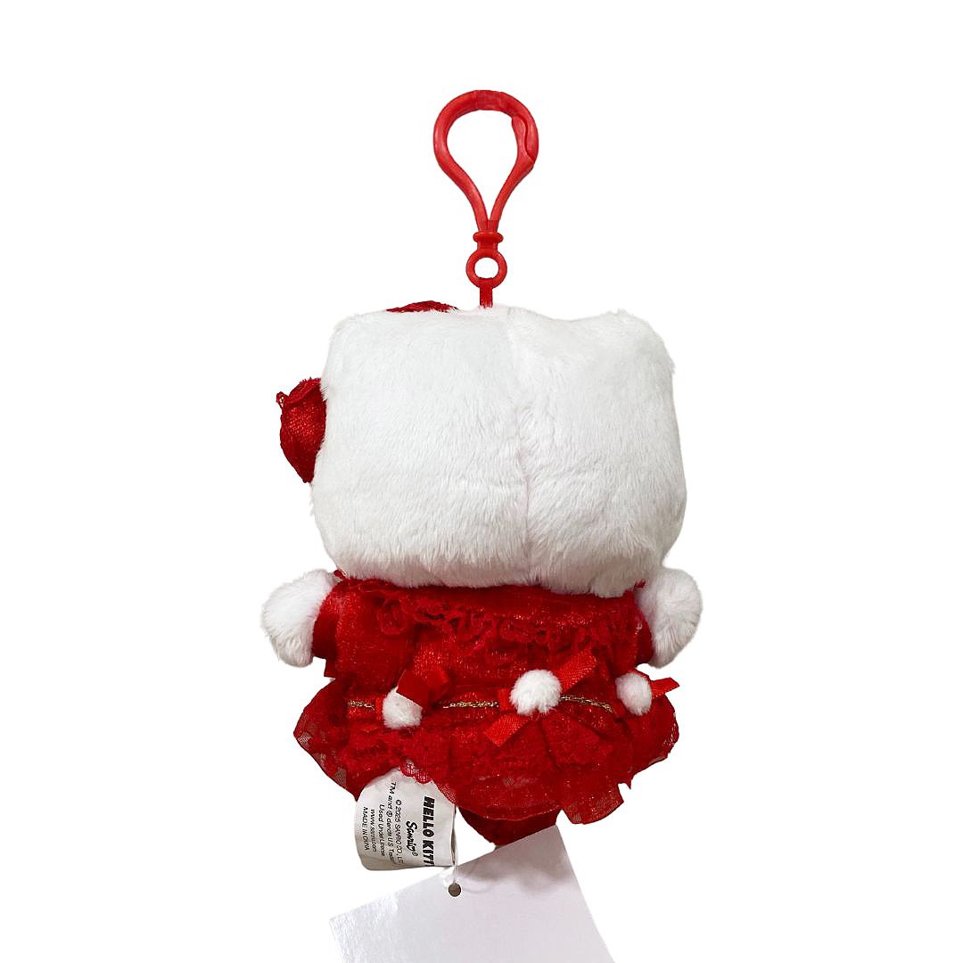 Officially licensed by Hello Kitty  Plush keychain in a red dress with white accent pompom on a white background. she’s perfect for cuddling, displaying, or gifting Christmas to Sanrio fans of all ages.