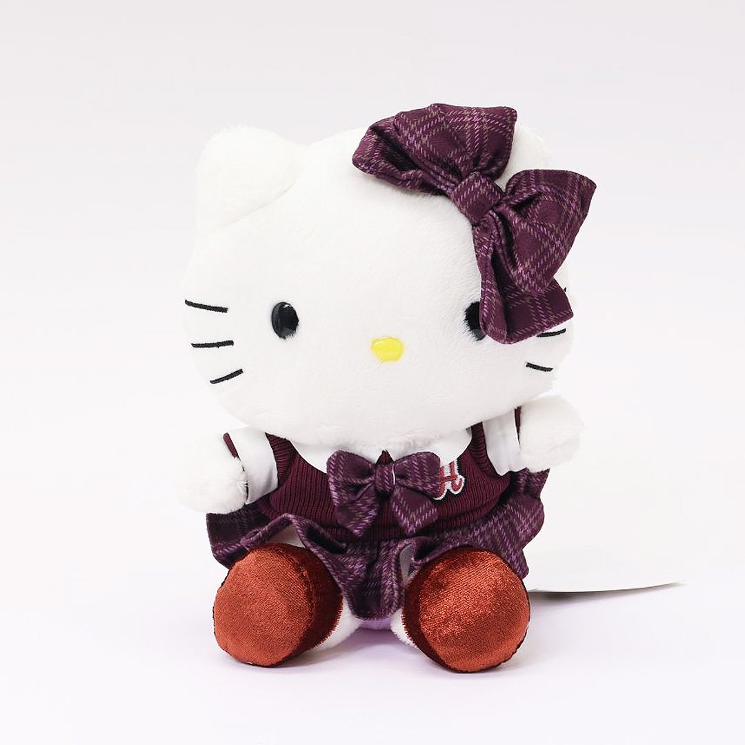 Officially licensed Hello Kitty 8-inch plush doll wearing a maroon and plaid school uniform, featuring a large matching plaid bow and reddish-brown velvet feet. Ideal collectible toy for fans and Sanrio enthusiasts.