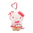 Officially licensed Sanrio Hello Kitty plush keychain from the Strawberry News 50th Anniversary Series. The plush wears a strawberry-patterned dress with pink ruffles and gold shoes, featuring a fuzzy pink bow and a metallic pink heart-shaped carabiner. Perfect displaying, bag decoration or gifting Valentine's day gift to Sanrio fans of all ages.