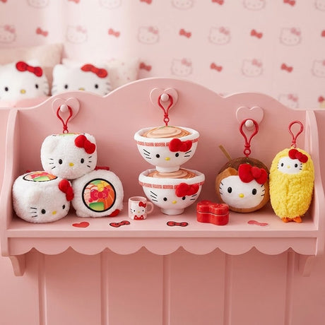 A collection of officially licensed Sanrio plush clips featuring Hello Kitty as various Japanese foods, including a ramen bowl, a sushi roll, a piece of tempura shrimp, and a takoyaki ball, each with a red attachment clip.