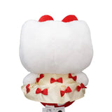 An officially licensed Hello Kitty plush doll wearing a cream-colored satin dress decorated with small red bows. She has a large red plush bow on her head and a second smaller red bow on her other ear.
