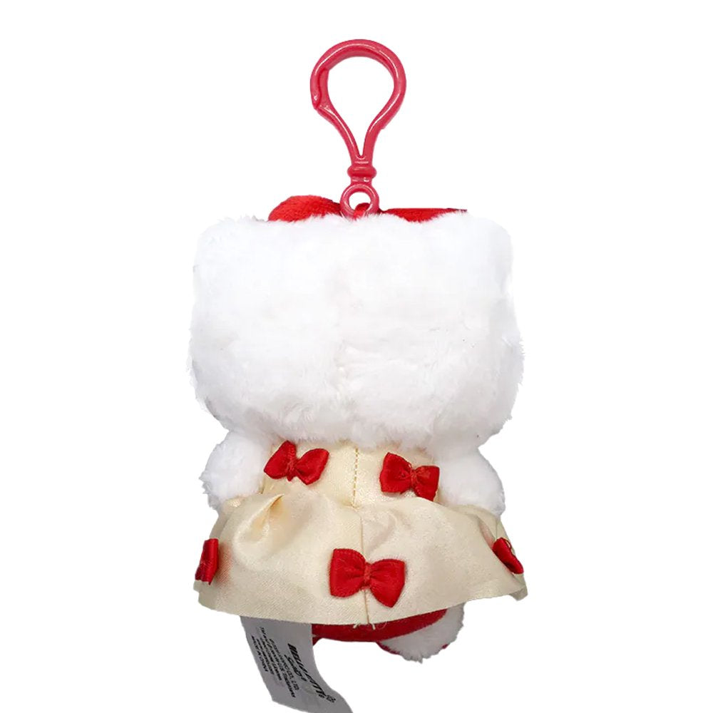 An officially licensed Hello Kitty plush keychain wearing a cream-colored satin dress decorated with small red bows. She has a big red plush bow on her head and a second smaller red bow on her other ear.