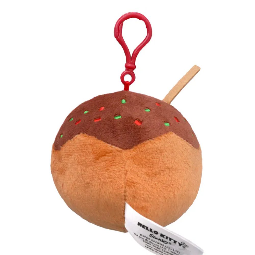 An officially licensed Sanrio plush keychain featuring Hello Kitty as a takoyaki ball with brown sauce, green sprinkles, and a small plush skewer. The round plush includes a red plastic attachment clip at the top.