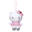 An officially licensed Sanrio Hello Kitty plush keychain featuring a white kitty with heart-shaped eyes, a pink leopard print dress, and a matching bow with a red jewel. The mascot includes metallic silver shoes and a pink elastic hanging loop.