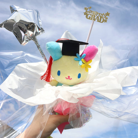 An officially licensed Class of 2026 Sanrio graduation gift set featuring Usahana wearing black graduation cap. The character is arranged like a bouquet with silver star balloon and "Congrats Grad" decoration.