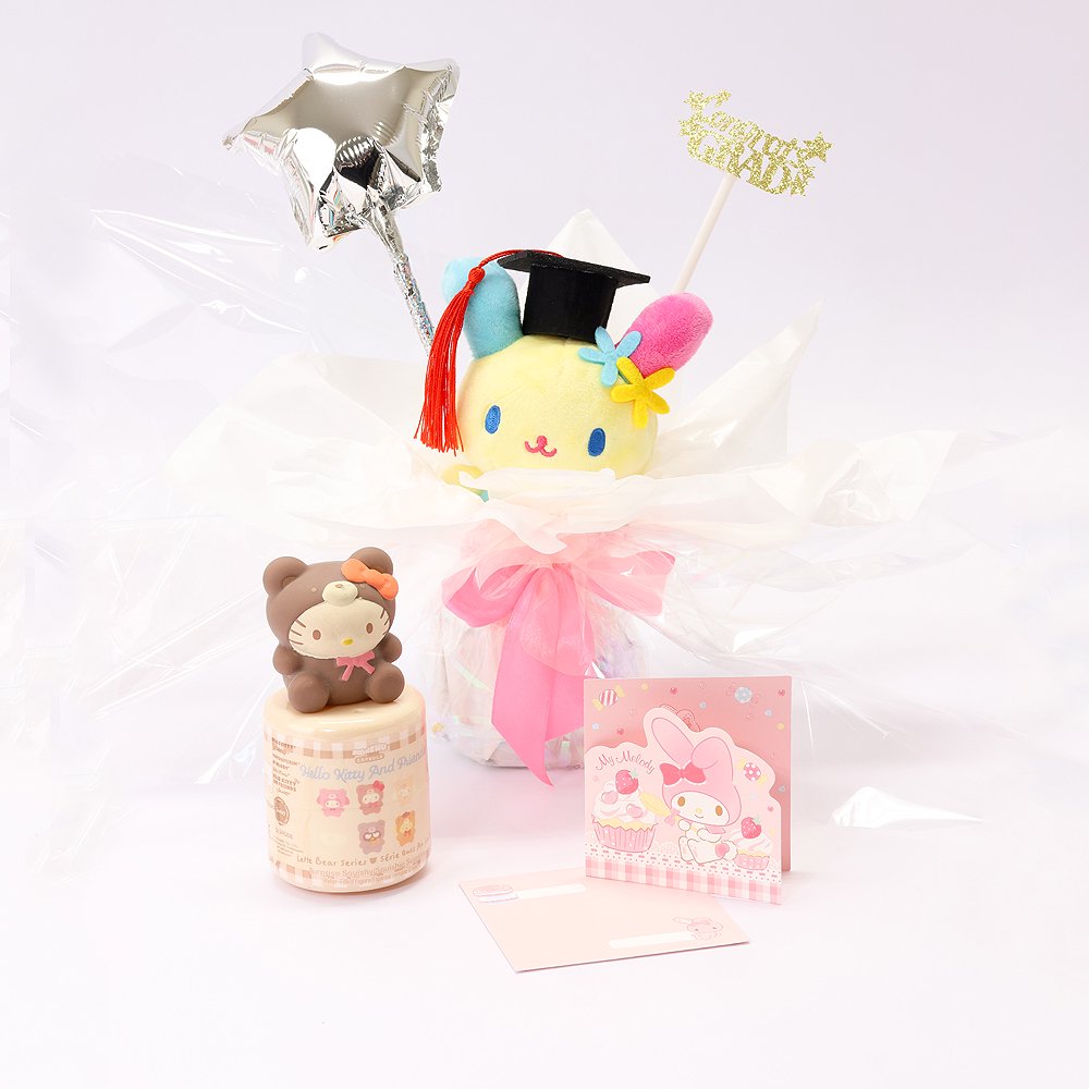 An officially licensed Class of 2026 Sanrio graduation gift set featuring six popular plush characters, Usahana, Corocorokuririn, Wish Me Mell, and Dinguri Days Mashu wearing black graduation caps. The characters are arranged like a bouquet with silver star balloons and "Congrats Grad" decorations.