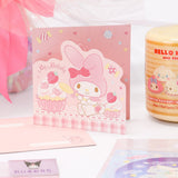 An officially licensed Class of 2026 Sanrio graduation gift set featuring six popular plush characters, Usahana, Corocorokuririn, Wish Me Mell, and Dinguri Days Mashu wearing black graduation caps. The characters are arranged like a bouquet with silver star balloons and "Congrats Grad" decorations.