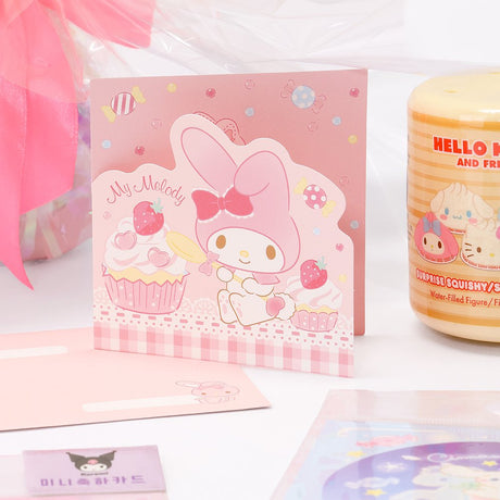 An officially licensed Class of 2026 Sanrio graduation gift set featuring six popular plush characters, Usahana, Corocorokuririn, Wish Me Mell, and Dinguri Days Mashu wearing black graduation caps. The characters are arranged like a bouquet with silver star balloons and "Congrats Grad" decorations.