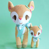 Two Sanrio Hummingmint plush deer toys with a larger one wearing a turquoise bow and a smaller one next to it on a teal background.