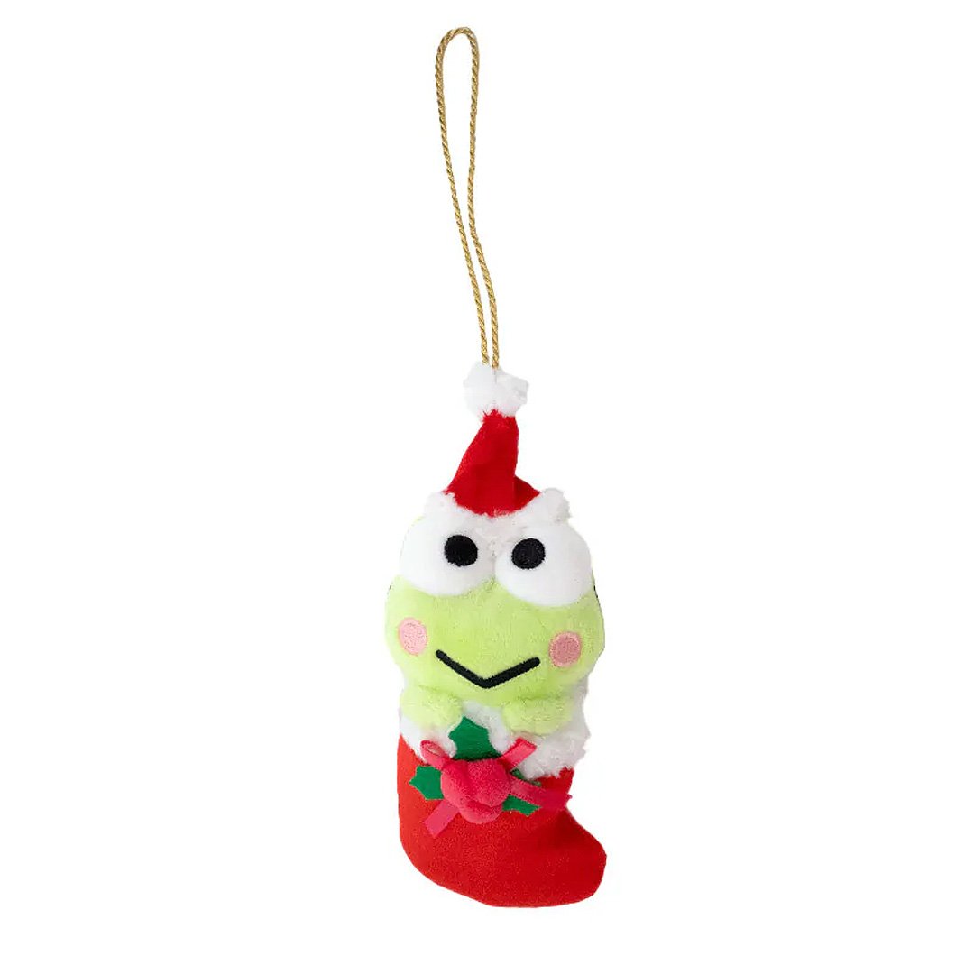 Sanrio Keroppi is dressed for the season wearing a red Santa hat with a white pom-pom while sporting his signature red bow. He sits snugly in a red Christmas stocking adorned with green holly leaves and a decorative ribbon. Crafted from soft plush material, this ornament has a cozy, huggable feel. The attached gold cord loop makes it easy to hang on your Christmas tree.