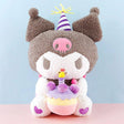 Officially licensed Sanrio Kuromi plush, wearing a charming party hat topped with a bright yellow tassel, and holding a cake for celebrating a special day