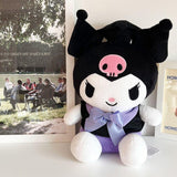 An officially licensed Sanrio Kuromi plush toy dressed in a black graduation cap with a gold tassel and a matching gown featuring a large light purple bow