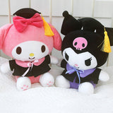 An officially licensed Sanrio Kuromi plush toy dressed in a black graduation cap with a gold tassel and a matching gown featuring a large light purple bow