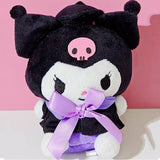 An officially licensed Sanrio Kuromi plush toy dressed in a black graduation cap with a gold tassel and a matching gown featuring a large light purple bow