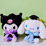 An officially licensed Sanrio Kuromi plush toy dressed in a black graduation cap with a gold tassel and a matching gown featuring a large light purple bow