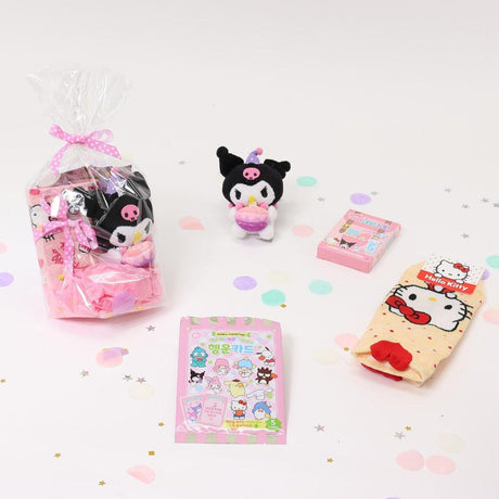 A collection of Sanrio Happy Birthday themed gift sets, each containing various colorful items such as plush keychains and socks, all packaged in clear gift bags with pink ribbons.