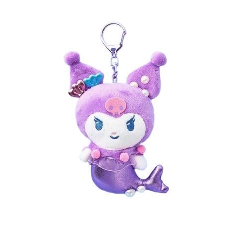 An officially licensed Sanrio character, Kuromi mermaid plush keychain featuring a metallic purple tail, a purple jester hood with a pink skull emblem, and small shell and pearl accessories. She has a sheer purple ruffle with pink pom-poms around her waist and a silver metal clip.