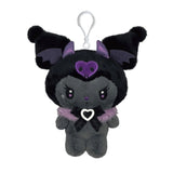 An officially licensed Kuromi plush keychain dressed in a black gothic outfit with purple bat wings and horns. She wears a fuzzy purple collar and a black lace bow, with a white plastic clip attached to her head.
