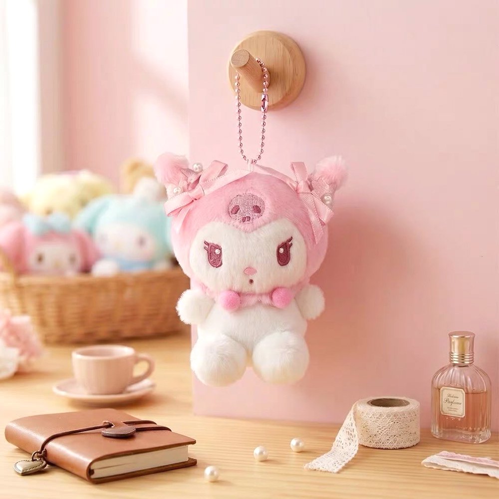 Officially licensed Sanrio Kuromi pink tone plush keychain styled in dreamy pastel pink and soft white hues with color-matched embroidered features, dangling from a ball chain