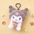 A high-texture, shaggy grey and white Kuromi plush keychain holding a small brown chocolate chip cookie. She features a classic look with pink blushed cheeks, attached to a grey heart-shaped plastic clip.
