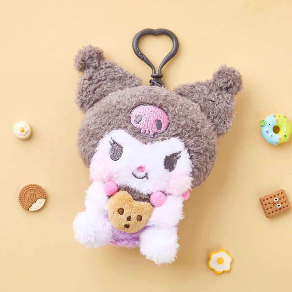 A high-texture, shaggy grey and white Kuromi plush keychain holding a small brown chocolate chip cookie. She features a classic look with pink blushed cheeks, attached to a grey heart-shaped plastic clip.