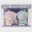 An officially lincensed Sanrio character plush set of the Little Twin Stars, Kiki and Lala, wearing unicorn-themed hoodies with gold crowns and horns. Kiki is on the right in a blue hood and purple shorts, while Lala is on the left in a pink hood with long braids and a white dress.