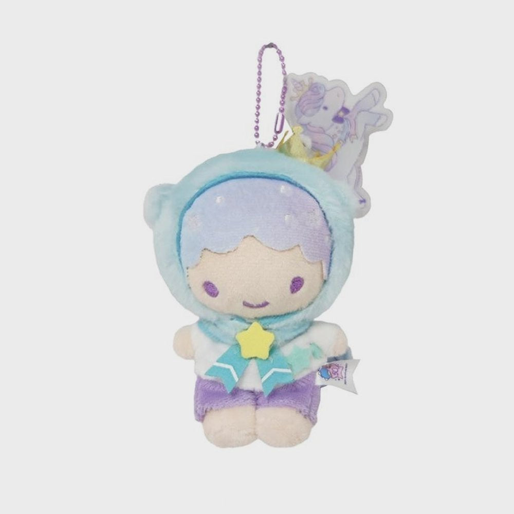 An officially licensed Sanrio Kiki Little Twin Stars plush keychain wearing a blue unicorn hood with a gold crown and horn. The plush has purple shorts, a star-shaped bow, and is attached to a purple ball chain with a unicorn acrylic charm.