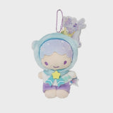 An officially licensed Sanrio Kiki Little Twin Stars plush keychain wearing a blue unicorn hood with a gold crown and horn. The plush has purple shorts, a star-shaped bow, and is attached to a purple ball chain with a unicorn acrylic charm.
