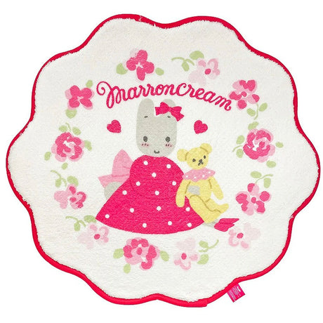 Round plush toy with cartoon character and teddy bear, surrounded by flowers and 'Marron Cream' text.