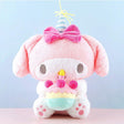 Officially licensed Sanrio My Melody plush, wearing a charming white party hat topped with a bright yellow tassel, and holding a cake for celebrating a special day.