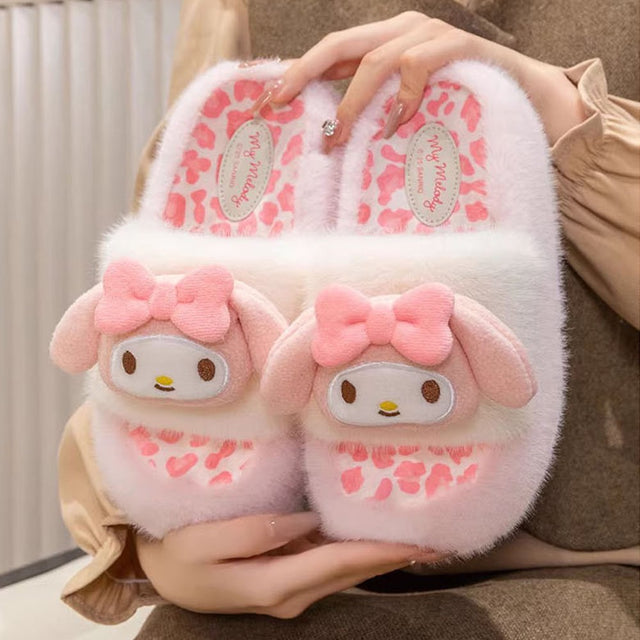 A pair of officially licensed Sanrio My Melody plush slippers featuring soft pink and white faux fur, a leopard print footbed, and a 3D plush My Melody face with pink bows on top.