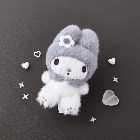 An officially licensed Sanrio character features a soft, fuzzy white body and a cozy grey hood adorned with a delicate white flower. The ultra-soft, long-pile fabric makes this stuffed animal incredibly huggable and a perfect addition to any collection. Its monochrome color palette gives it a modern, sophisticated look that fits well with various decor styles, from nurseries to adult bedrooms.