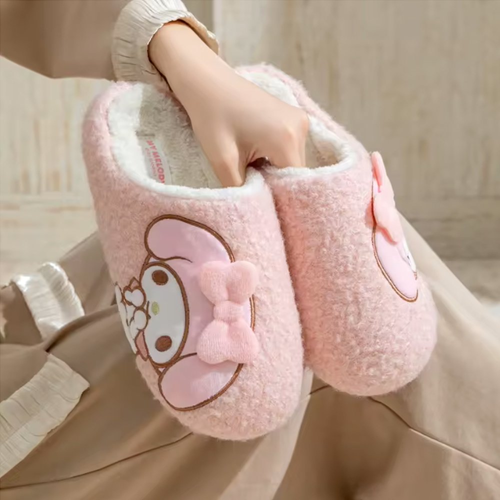 A pair of soft pink textured sherpa fleece My Melody slippers with a white fleece interior, featuring a side-profile My Melody embroidery with a 3D fuzzy pink bow.