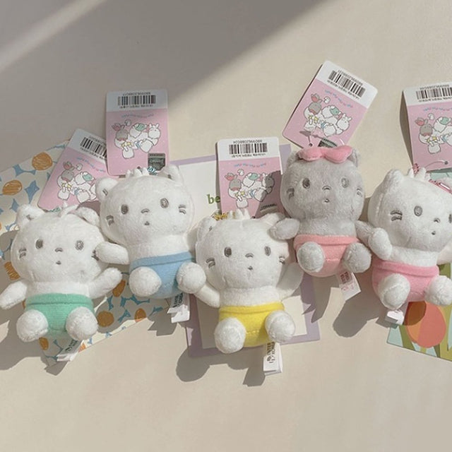 Sanrio Official License Nya Ni Nyu Nye Nyon plush keychains set featuring five white and gray baby cats wearing small pastel-colored diapers or pants.