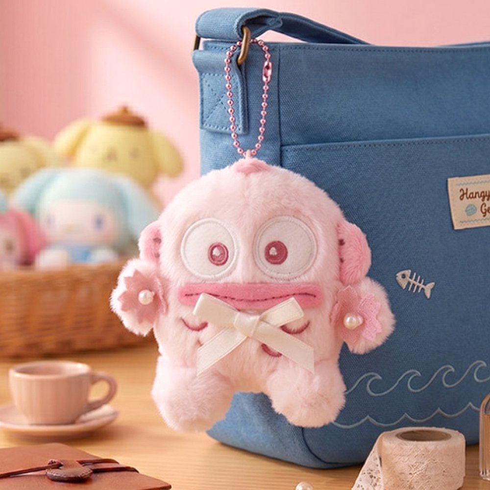 Officially licensed Sanrio collection of pink tone plush keychains adorned with cherry blossom flower crowns, pearl details, and satin bows