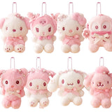 Officially licensed Sanrio collection of pink tone plush keychains adorned with cherry blossom flower crowns, pearl details, and satin bows